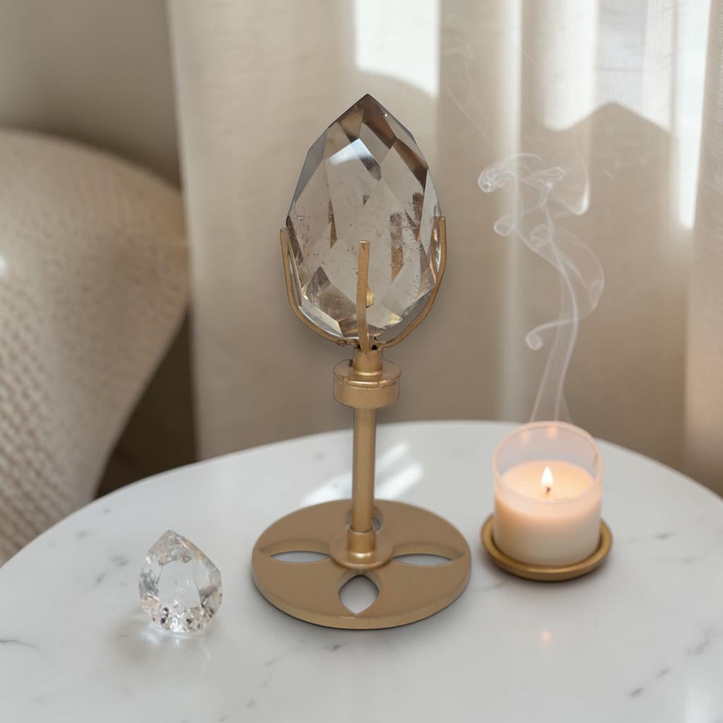 Smoky quartz faceted freeform on gold rotating stand, teardrop crystal with facets