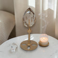 Smoky quartz faceted freeform on gold rotating stand, teardrop crystal with facets