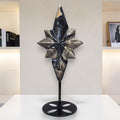 Volcanic agate star crystal carving on black display stand, dark blue and cream