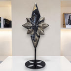 Volcanic agate star crystal carving on black display stand, dark blue and cream