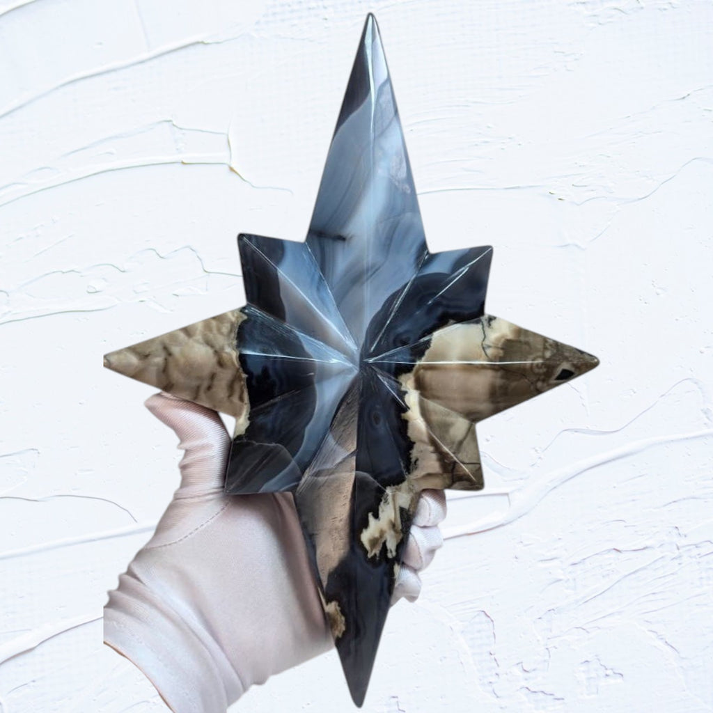 Star crystal decor sculpture with blue glow-like facets on a slender gold-toned stand.