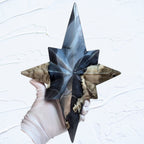 Star crystal decor sculpture with blue glow-like facets on a slender gold-toned stand.