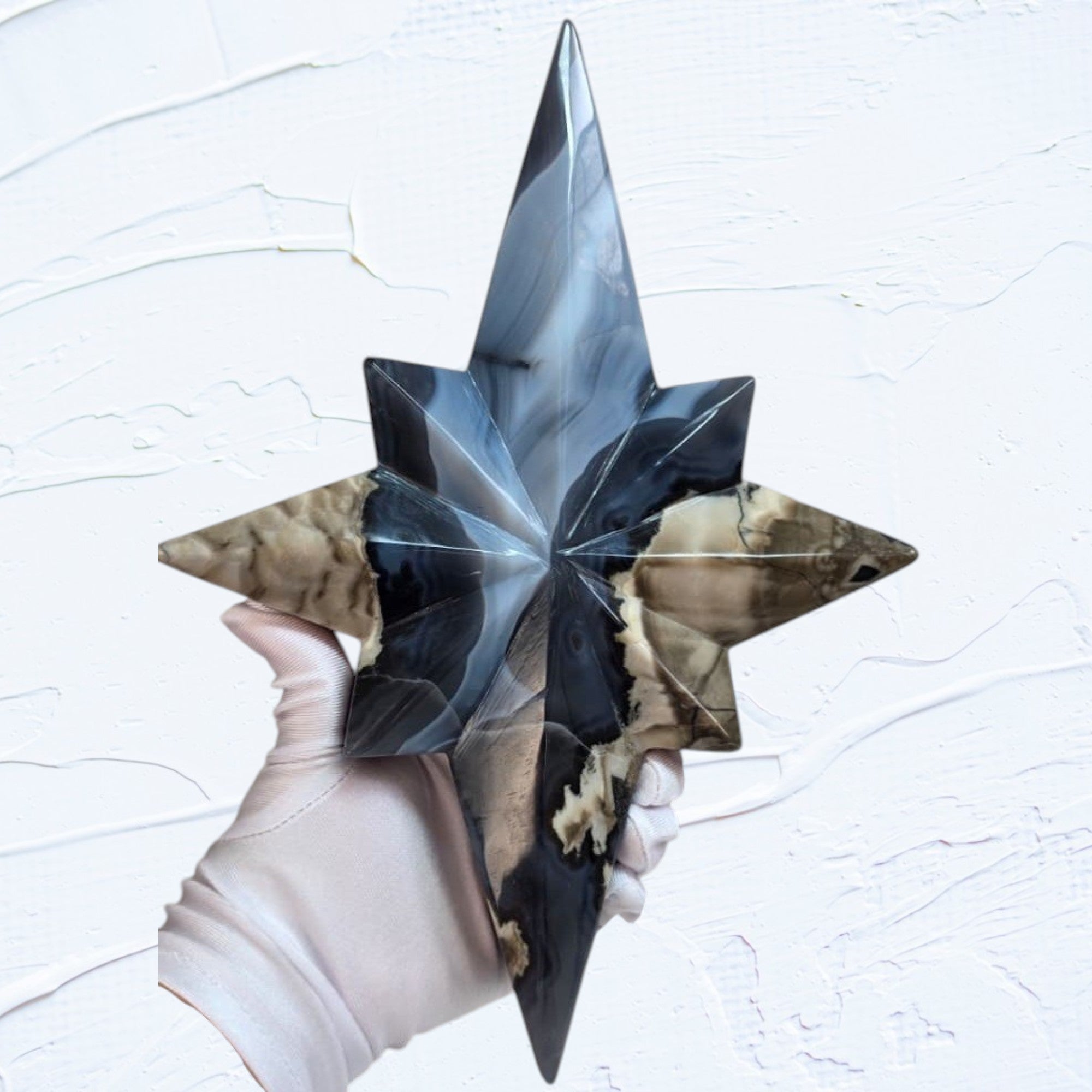 Star crystal decor sculpture with blue glow-like facets on a slender gold-toned stand.