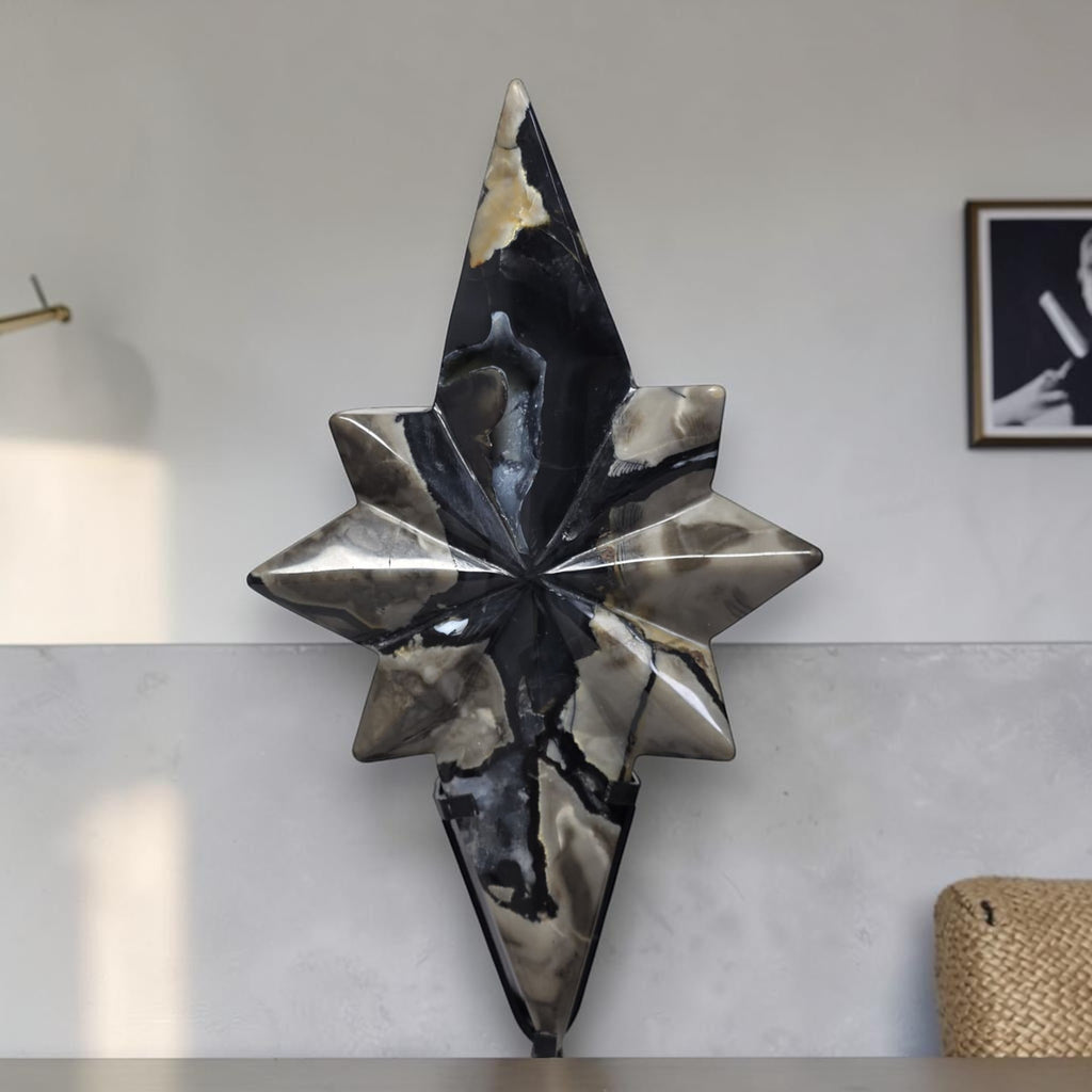 Polaris star crystal decor with pointed facets on black stand, dark blue and cream