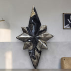 Polaris star crystal decor with pointed facets on black stand, dark blue and cream
