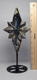 Polaris star crystal carving on black stand with height measurement, dark blue and cream