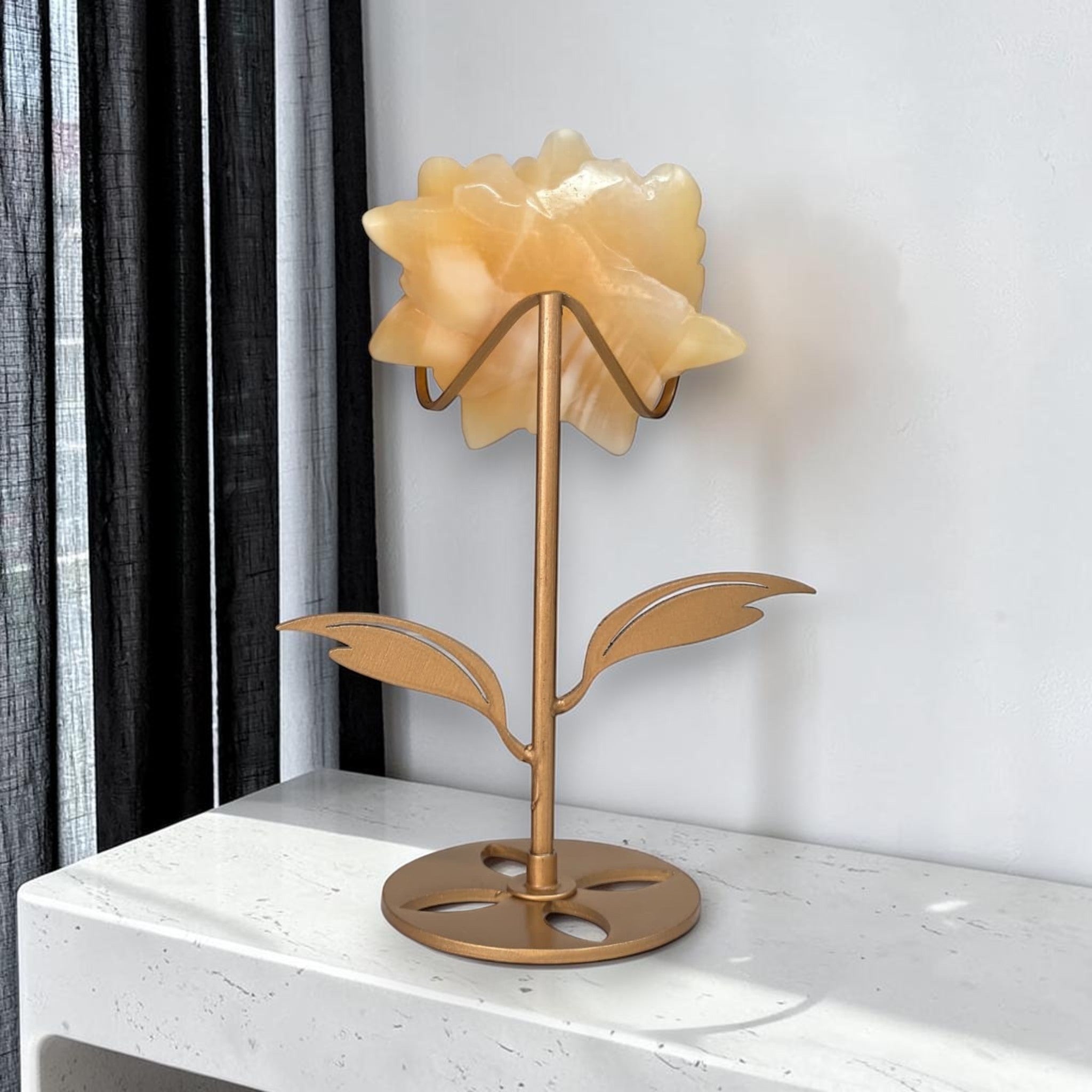 Yellow calcite rose carving on gold stand, back view